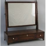 A 19th Century mahogany toilet mirror, the oblong plate on reeded uprights with metal acorn