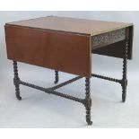 A mahogany and stained beech drop leaf table, the oblong top with brass edging on base with