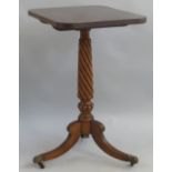 A mahogany tripod table, the reeded edged oblong tilt top on wrythen turned stem and reeded