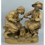 A Friedrich Goldscheider painted terracotta group, of two boys seated on a log playing cards,