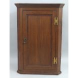 A 19th Century oak corner cupboard, with mahogany cross banding, wall hanging, having moulded