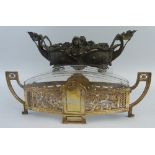An early 20th Century Kayser table centrepiece, of oval two handled form, the brassed metal frame