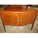 An early 20th Century mahogany sideboard by Maple & Co, of serpentine form with satinwood inlay, two