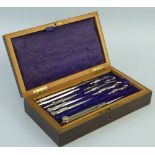 A 19th Century rosewood drawing instrument box, of oblong form, the hinged lid opening to reveal a