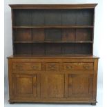 A 19th Century oak enclosed dresser and rack, having flared cornice over two shelves, the protruding