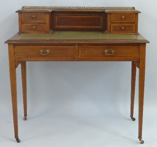 An Edwardian mahogany writing desk, with satinwood banding, having pierced gilt metal gallery over