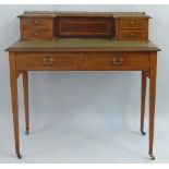 An Edwardian mahogany writing desk, with satinwood banding, having pierced gilt metal gallery over