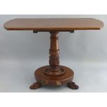 A  William IV mahogany breakfast table, the rounded oblong top on turned stem with carved stiff leaf