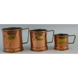 A graduated set of three seamed copper grain measures, of cylindrical tankard form, largest 11cm