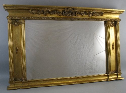 A gilt framed overmantle mirror, of oblong form with plain top, concave cornice with scrolling