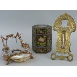 A French brass desk stand, the open framework cast with flowers and leaves and three hoof feet,