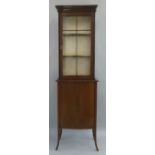 An Edwardian mahogany display cabinet, with satinwood stringing having concave stepped cornice