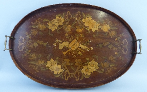 A mahogany and marquetry gallery tray, of oval form, the centre inlaid with musical trophies