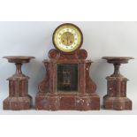 A late 19th Century French three piece clock garniture, the eight day movement striking on a bell