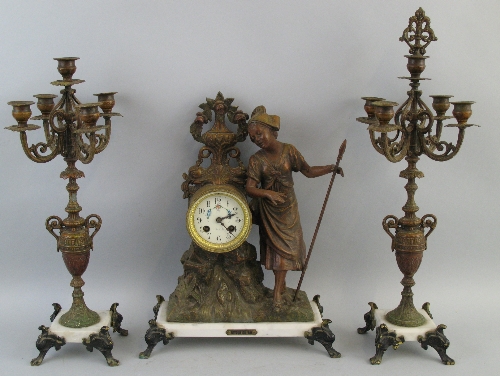 A late 19th Century French three piece garniture de cheminee, with drum shaped part movement,