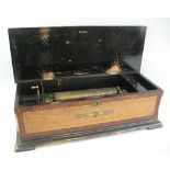 A late 19th Century musical box, of oblong form, the 28cm cylinder playing eight airs but lacking