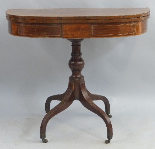 A mahogany tea table, with satinwood stringing, the D shaped fold over top on faux panelled frieze