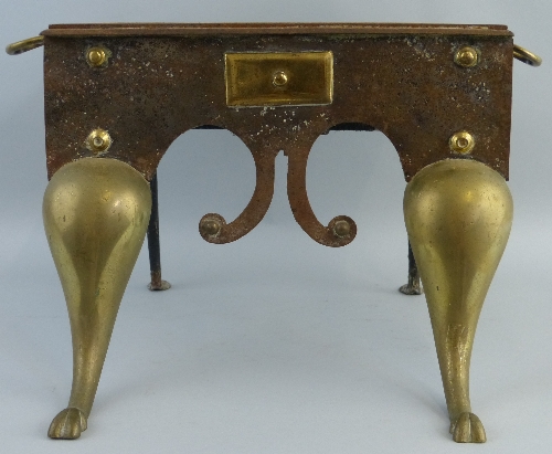 A 19th Century brass and iron footman, the oblong top with two carrying handles over a shaped