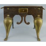 A 19th Century brass and iron footman, the oblong top with two carrying handles over a shaped