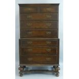 An Edwardian oak chest on chest, Queen Anne style with flared cornice over two short and three