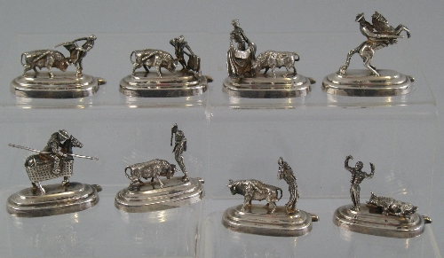 A set of eight Spanish place name holders, each differently modelled as a matador at various