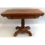 An early 19th Century mahogany fold over tea table, the D-shaped top with reeded edge over a