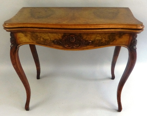 A 19th Century walnut fold over card table, of serpentine form, the burr walnut top and apron with