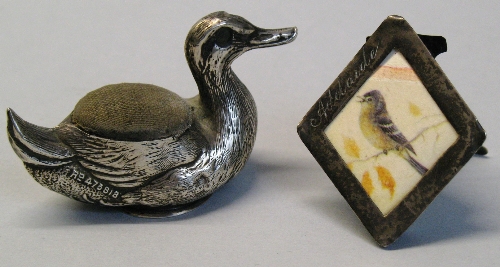 An Edwardian pin cushion, in the form of a duck, 6cm long, Birmingham 1906 and a Victorian miniature