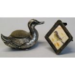An Edwardian pin cushion, in the form of a duck, 6cm long, Birmingham 1906 and a Victorian miniature