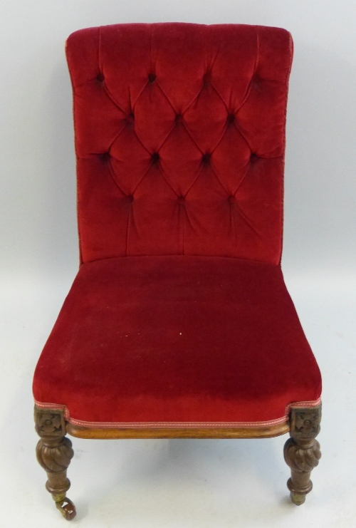 A Victorian oak framed nursing chair, with button upholstered back, overstuffed seat on carved,