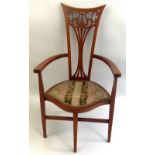 An Edwardian mahogany elbow chair, with boxwood and satinwood inlay, the narrow pierced back with