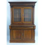 A 19th Century rosewood bookcase on cabinet, having egg and dart carved flared cornice over two