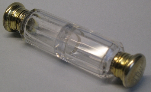 A Victorian double ended scent bottle, the faceted clear glass body with two monogrammed silver gilt