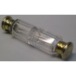 A Victorian double ended scent bottle, the faceted clear glass body with two monogrammed silver gilt