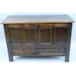 An 18th Century oak mule chest, the moulded edged two plank oblong top over a frieze carved with
