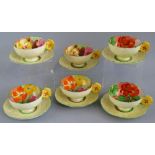 A set of six Paragon bone china cups and saucers, each moulded, printed and painted with flowers and