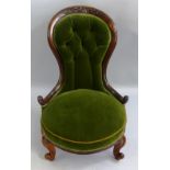 A Victorian walnut framed nursing chair, the waisted button upholstered back with scroll carved