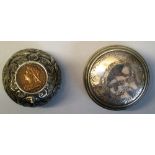 A Victorian pill box, of bun form embossed with scrolling leaves, the hinged lid inset with a