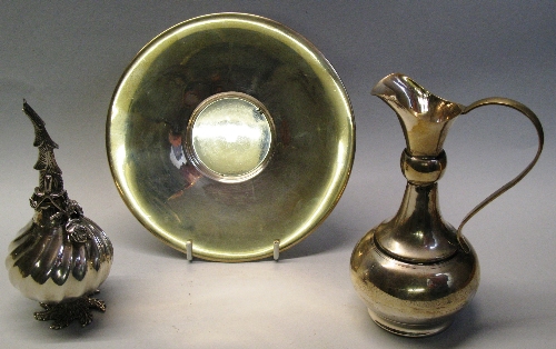 A continental white metal ewer and stand, the ewer of bottle shaped form with bulbous collar to
