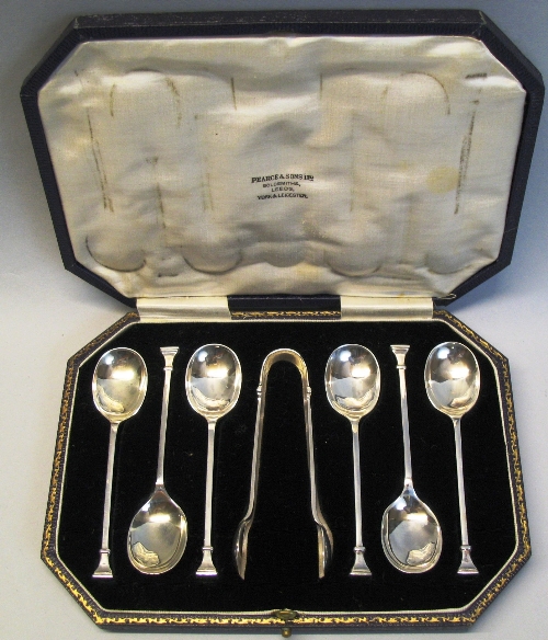 A set of six coffee spoons and matching sugar tongs, with oblong seal terminals, cased, Sheffield