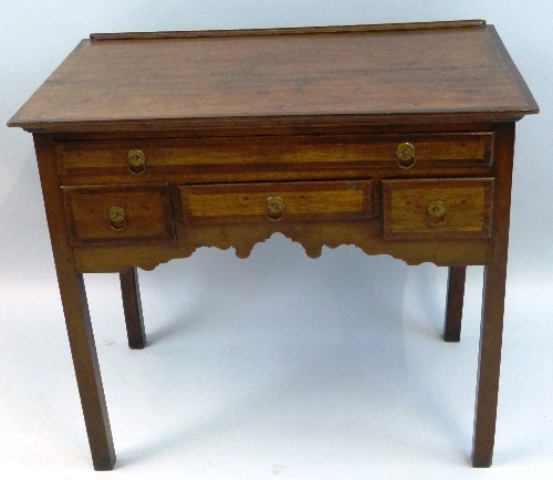 A 19th Century oak lowboy, the oblong top with mahogany cross banding over four frieze drawers