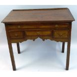 A 19th Century oak lowboy, the oblong top with mahogany cross banding over four frieze drawers