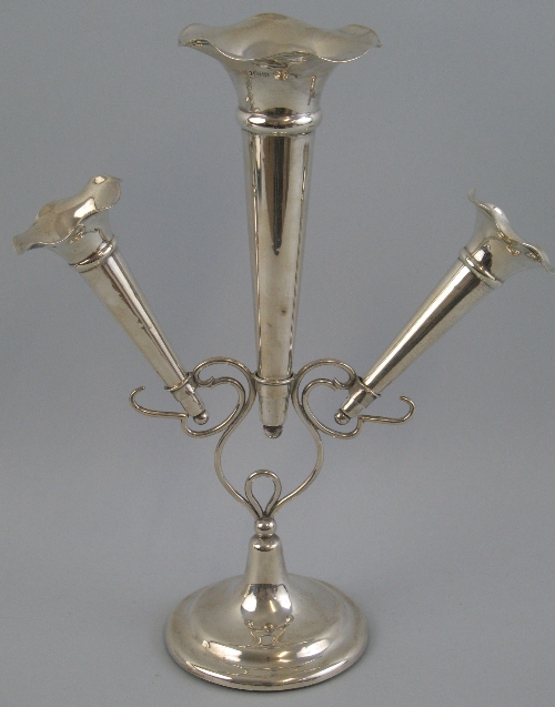 An Edwardian epergne, the Art Nouveau style open wire work frame supporting one large and two