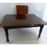 A 19th Century mahogany dining table, the half round ends with fixed centre leaf, plain tapering