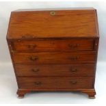 A 19th Century mahogany bureau, the fall front opening to reveal a fitted interior with boxwood