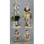 A pair of Sitzendorf figures, of a man and woman in 18th Century costume, he standing beside a