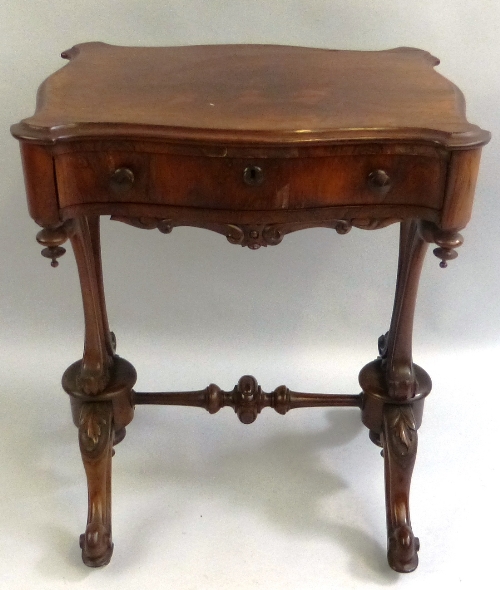 A Victorian rosewood work table, stamped T Feetham Maker Hull, the top of serpentine oblong form