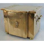 An early 20th Century brass coal box, of breakfront form, the hinged lid with flowerhead studs