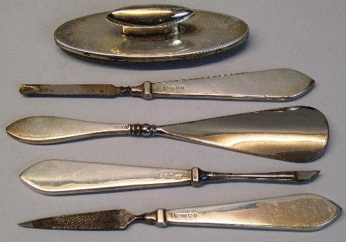 A manicure set, comprising three tools and shoe horn with plain flattened oblong tapering hafts