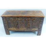 A late 17th/18th Century oak coffer, with replacement stained pine lift off lid over a three panel